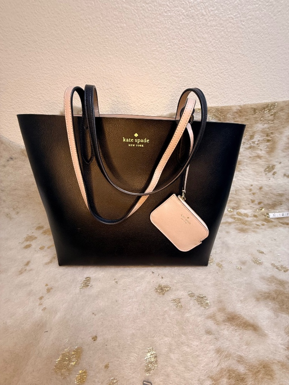 Stylish Kate Spade reversible tote in classic black with blush pink interior
